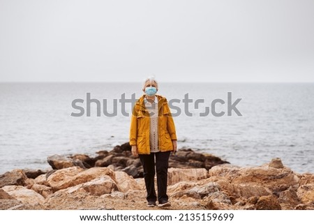 Similar – Senior sportswoman looking at the sea