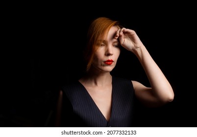 A Middle-aged Woman In Her Forties In Mental Decline, Upset, Thoughtful On A Black Background. Crisis Concept.