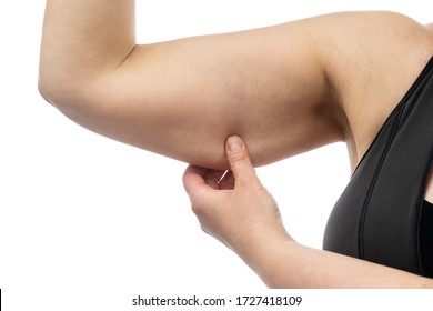 Middle-aged woman holding a hand with excess fat. On a white background, Isolated.