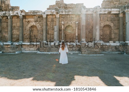 Similar – Woman Walking Through Building