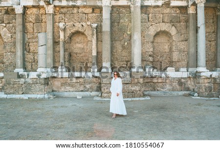 Similar – Woman Walking Through Building