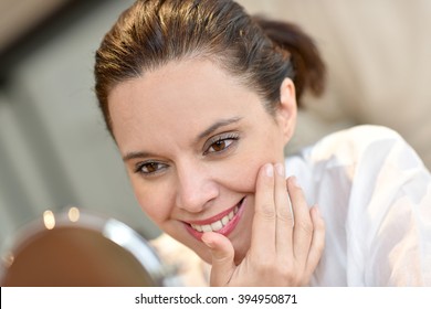 Middle-aged Woman Looking At Mirror