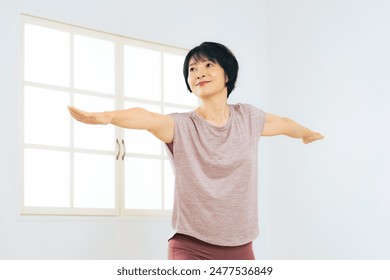 Middle-aged woman practicing yoga in a yoga studio - Powered by Shutterstock