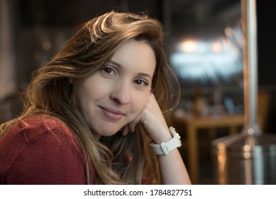 Middle-aged Woman With Subtle Smile In A Restaurant