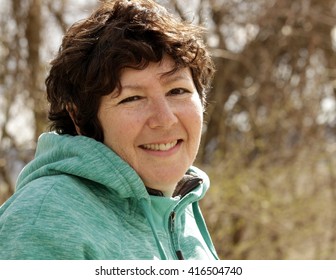 Middle-aged Woman Talking A Walk In A Park; Fall In The Midwest