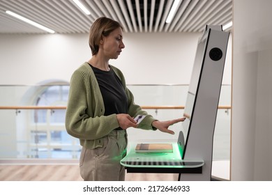 Middle-aged Woman Using Self-service Terminal In Digital Library Space, Registering Book, Searching And Selecting Literature Or Browsing Catalogue. Innovative Technologies In Libraries