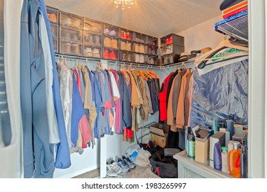 Middleburg,, Florida USA - May 31 2021: Large Walk-in Closet Filled With Mens Clothes And Shoes