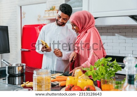 Middle-eastern couple wearing traditional arab clothing at home - Married arabian husband and wife bonding together in the apartment, concepts about relationship, domestic life and emirati lifestyle Foto stock © 