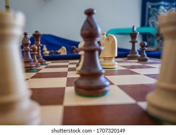 Middlegame Endgame On A Wooden Chessboard With Blue Background