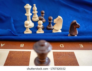 Middlegame Endgame On A Wooden Chessboard With Blue Background