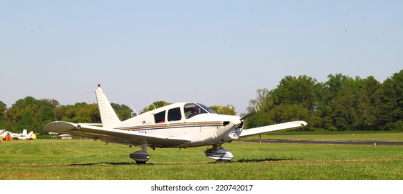 MIDDLESEX, VA - SEPTEMBER 27, 2014: A Small Private Plane Waiting To Access The Runway At Hummel Field Airport In The Wings Wheels And Keels Annual Show At The Hummel Airfield Airstrip In Middlesex VA