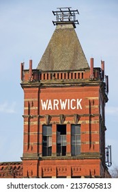 MIDDLETON, UK - March 21, 2022: An Old Victorian Red Brick Cotton Mill In Bright Sunlight