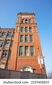 MIDDLETON, UK - March 21, 2022: An Old Victorian Red Brick Cotton Mill In Bright Sunlight