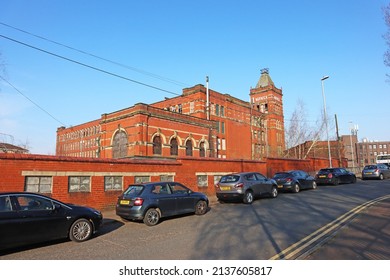 MIDDLETON, UK - March 21, 2022: An Old Victorian Red Brick Cotton Mill In Bright Sunlight