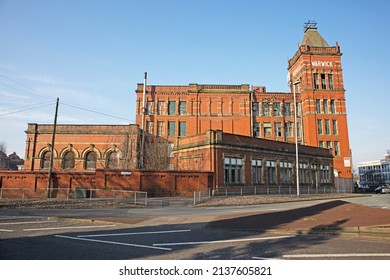 MIDDLETON, UK - March 21, 2022: An Old Victorian Red Brick Cotton Mill In Bright Sunlight