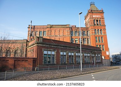 MIDDLETON, UK - March 21, 2022: An Old Victorian Red Brick Cotton Mill In Bright Sunlight