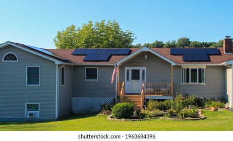 MIDDLETOWN, NY, UNITED STATES - Jul 14, 2020: Suburban Solar Pannel Home Ranch Style House With Car In Driveway, Real Estate, Green Home Technology, Eco Friendly Living, Bright Summer Day 