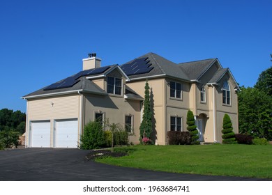 MIDDLETOWN, NY, UNITED STATES - Jul 14, 2020: Suburban Solar Pannel Home Two Story Large Home  Real Estate House With Solar Pannels On Roof, Green Home Technology, Eco Friendly Living  Sunny Day