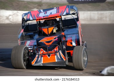 Middletown, NY, USA - April 2, 2022: Short Track Racer Charles Loiodice Hustles His Dirt Modified Stock Car Around The Dirt Track At Orange County Fair Speedway. 