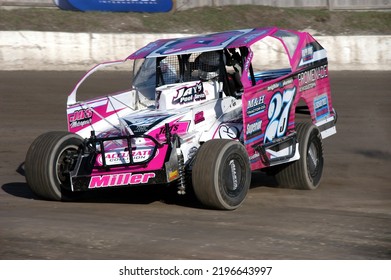 Middletown, NY, USA - April 2, 2022: Short Track Racer Jared Miller Hustles His Dirt Modified Stock Car Around Orange County Fair Speedway. Car Slightly Blurred To Depict Speed.