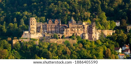 Midevil castle at sunset above city and river in dark forest in Heidelberg , Germany