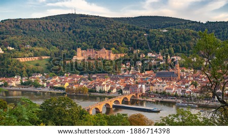 Midevil castle at sunset above city and river in dark forest in Heidelberg , Germany