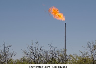 Midland, County / United States - April 21, 2019: Excess Natural Gas Is Burned Off At An Oil Well Site.