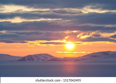 Midnight Sun In Spring In The Arctic. At The End Of May, On The Coast Of The Arctic Ocean, The Sun Does Not Go Beyond The Horizon All Night. East Siberian Sea, Chukotka, Russia. Polar Region.