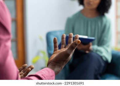 Midsection of african american male patient attending therapy with biracial female therapist. Mental health, therapy and counselling. - Powered by Shutterstock
