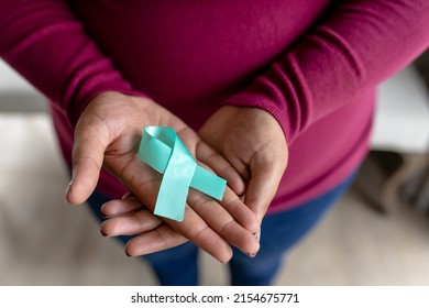 Midsection of african american mid adult woman with prostate cancer awareness blue ribbon. unaltered, cancer, healthcare and medicine and social awareness symbol concept. - Powered by Shutterstock