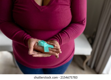 Midsection of african american mid adult woman showing prostate cancer awareness blue ribbon. unaltered, cancer, healthcare and medicine and social awareness symbol concept. - Powered by Shutterstock