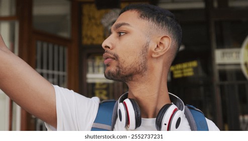 Midsection of biracial man drinking coffee and using smartphone in the street. backpacking holiday city travel break. - Powered by Shutterstock