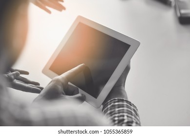 Midsection of businessman using digital tablet in office