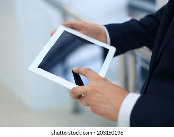 Midsection of businessman using digital tablet in office - Powered by Shutterstock - Get 15% off with code: PIKWIZARD15