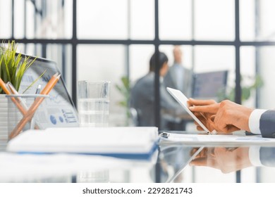 Midsection of businessman using digital tablet in office