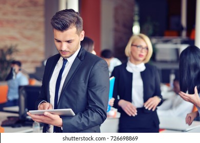 Midsection of businessman using digital tablet in office