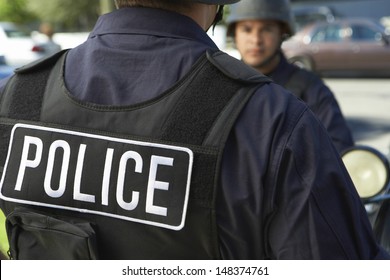 Midsection closeup of policeman wearing protective vest outdoors