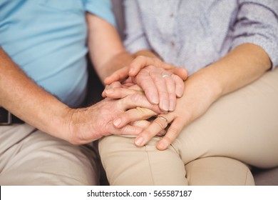 Midsection of couple holding hands while comferting eachother - Powered by Shutterstock