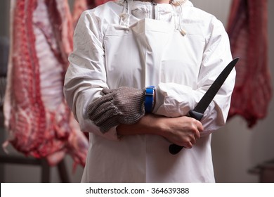 Midsection of female butcher sharpening knife to cut meat in butchery - Powered by Shutterstock