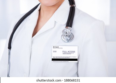 Midsection Of Female Doctor With ID Card And Stethoscope