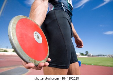 The midsection of a male athlete preparing to throw the disk in discus throw competition. - Powered by Shutterstock