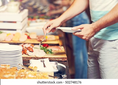 Midsection of man at breakfast buffet in hotel