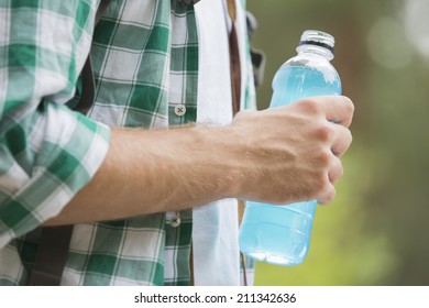 Midsection Of Man With Energy Drink Outdoors