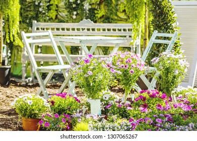 Midsection Of A Middle Aged Woman Planting Flowers In Garden