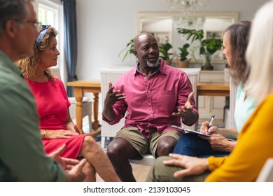 Midsection of multiracial senior males and females discussing during group therapy session. unaltered, support, alternative therapy, community outreach, mental wellbeing and social gathering. - Powered by Shutterstock