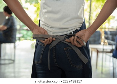 Midsection of waitress tying apron in cafe
 - Powered by Shutterstock