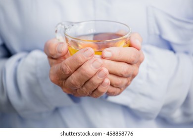 Midsection Of Woman Holding Herbal Tea