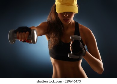 Midsection Of Woman Lifting Dumbells