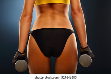 Midsection Of Woman Lifting Dumbells