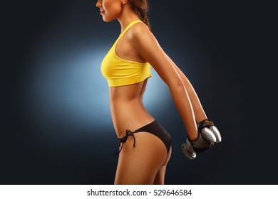 Midsection Of Woman Lifting Dumbells